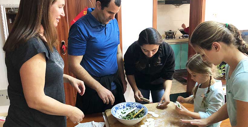 Parents and kids learning to make traditional Chinese dumplings in Xi'an